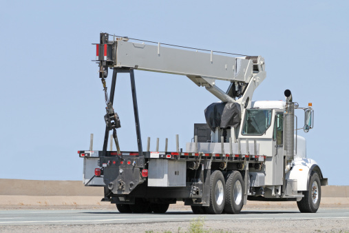 Truck mounted, extendable hydraulic crane commonly used for transporting and placing materials and supplies.