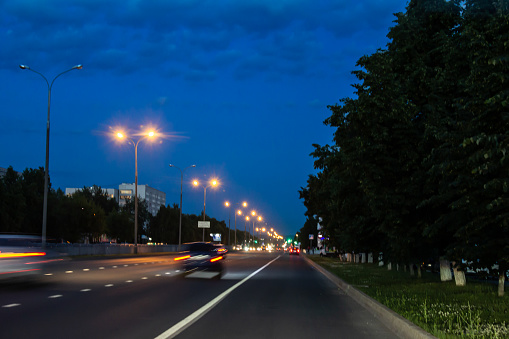 photo city at night, road, cars in the artistic treatment