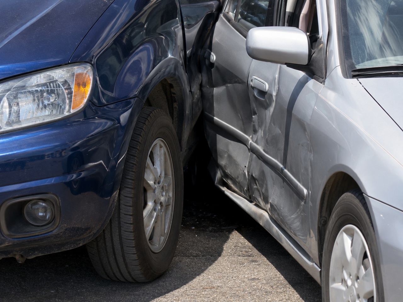 Close up of a side impact collision between two vehicles with a crumpled door panel on a Maryland roadway, illustrating a car accident case subject to the state's lawsuit filing deadline.